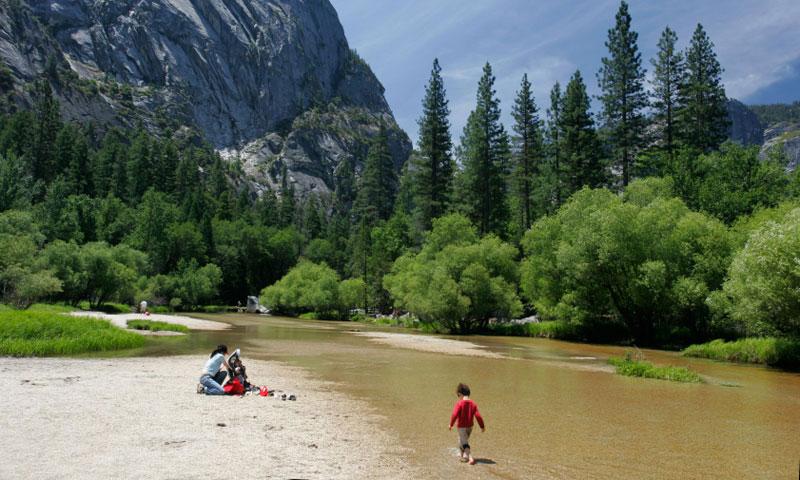 Kid playing in Merced River in Yosemite